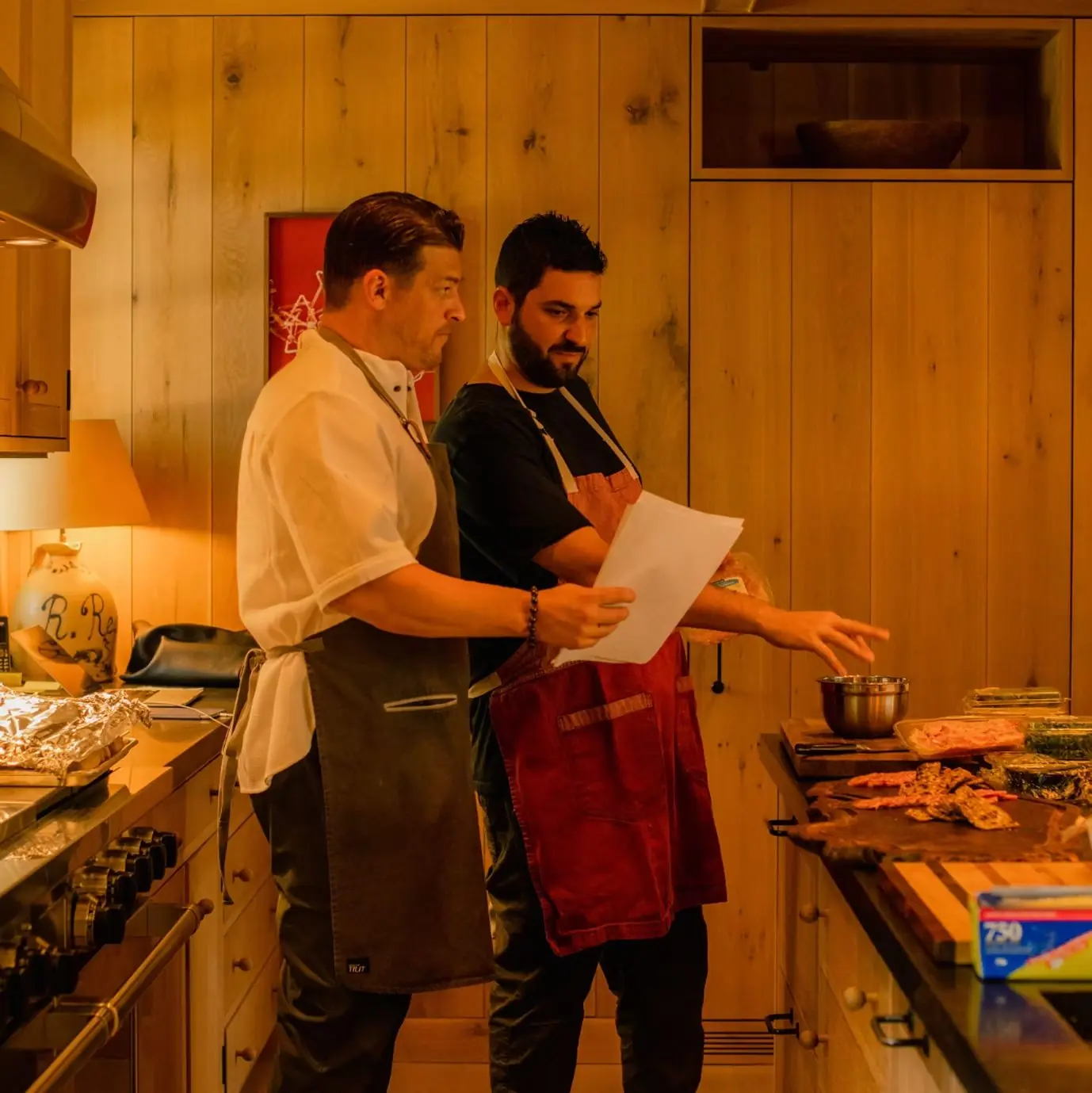 Chef Paul Aceto cooking alongside another chef