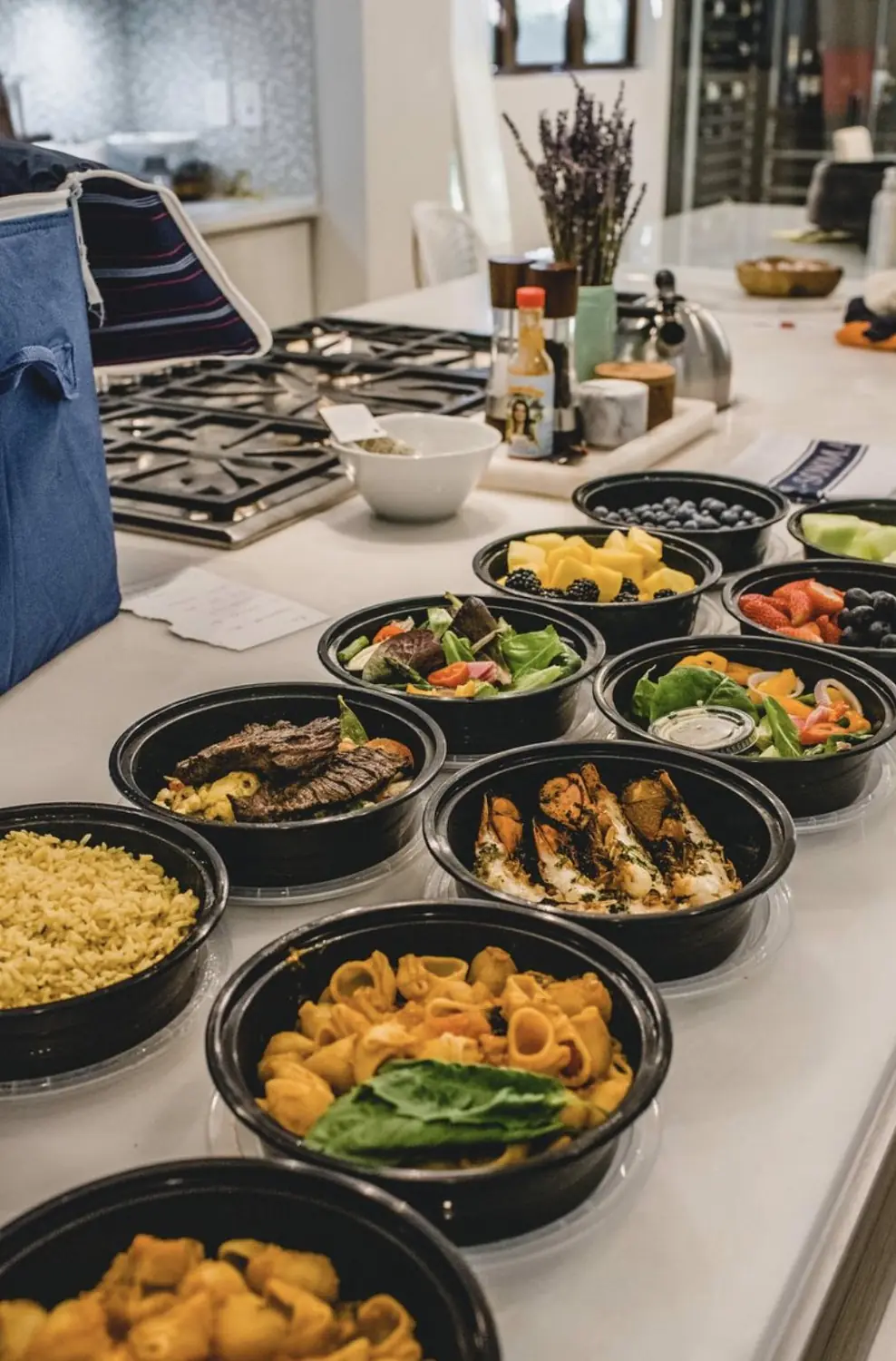 A week of meals prepared by Chef Paul Aceto, laid out on a client kitchen island
