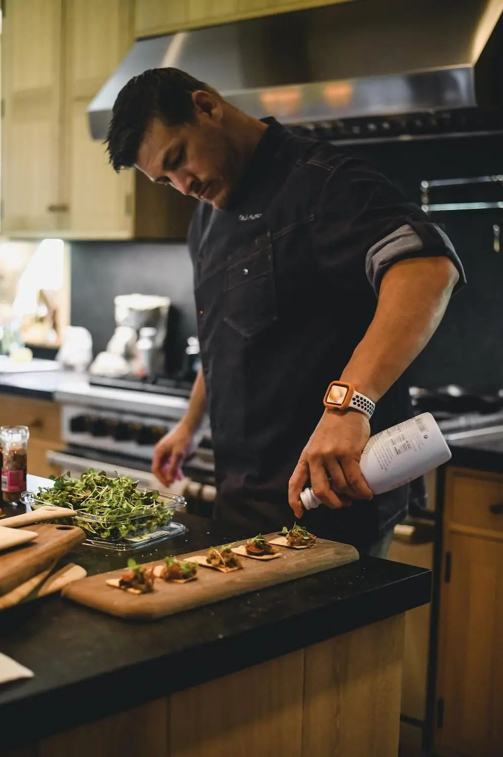 Chef Paul Aceto plating a private dinner at a client’s home